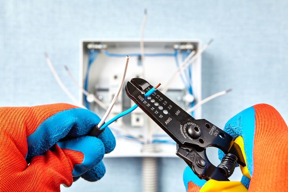 Professional Hot Shot Electric certified electrician upgrading breaker box – licensed Tulsa experts fix tripped breakers and install modern panels for safe home power.