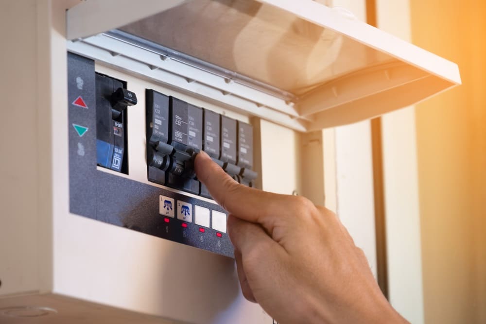 Professional Hot Shot Electric certified electrician upgrading breaker box – licensed Tulsa experts fix tripped breakers and install modern panels for safe home power.