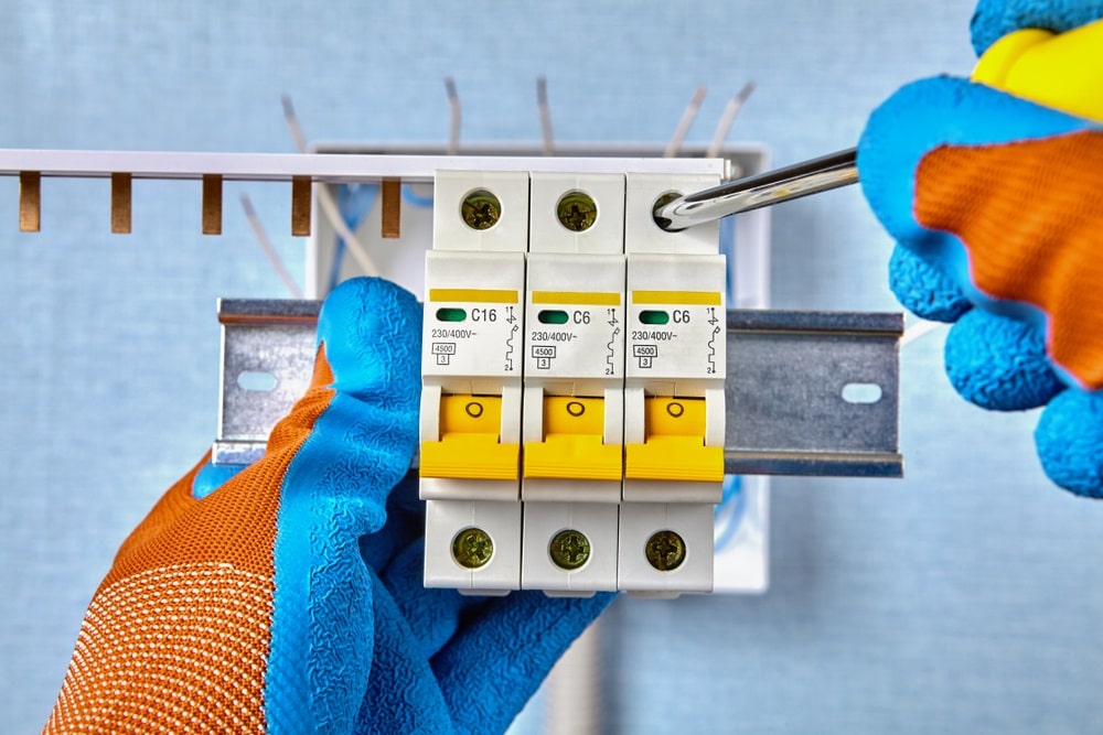 Professional Hot Shot Electric certified electrician upgrading breaker box – licensed Tulsa experts fix tripped breakers and install modern panels for safe home power.