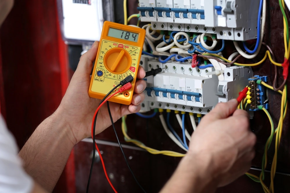 Professional Hot Shot Electric certified electrician upgrading breaker box – licensed Tulsa experts fix tripped breakers and install modern panels for safe home power.