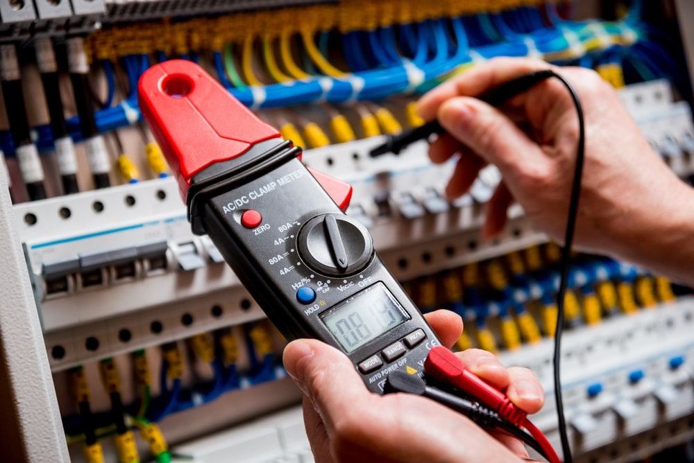 Professional Hot Shot Electric certified electrician upgrading breaker box – licensed Tulsa experts fix tripped breakers and install modern panels for safe home power.