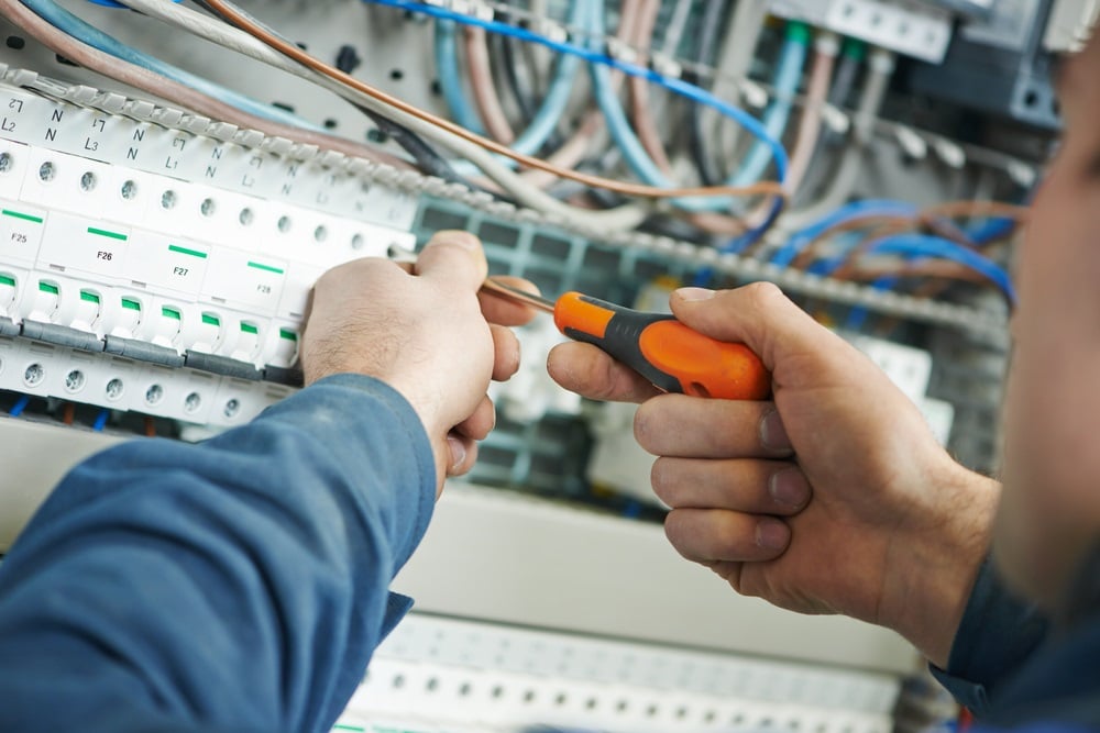 Professional Hot Shot Electric certified electrician upgrading breaker box – licensed Tulsa experts fix tripped breakers and install modern panels for safe home power.