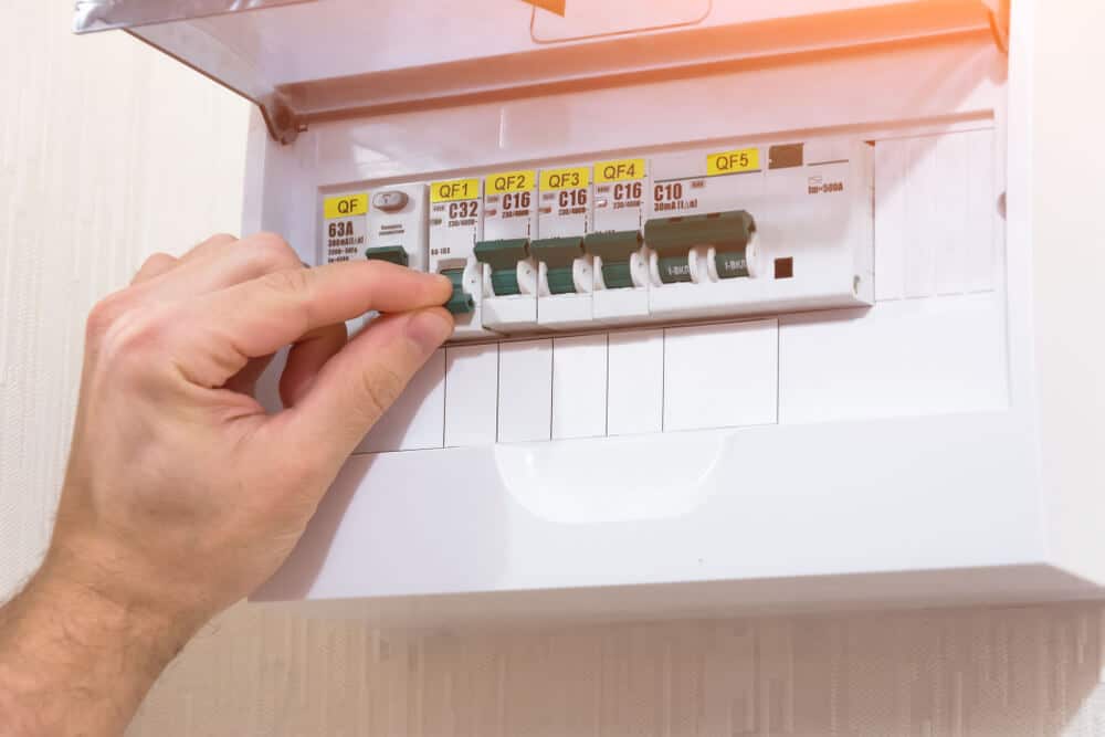 Professional Hot Shot Electric certified electrician upgrading breaker box – licensed Tulsa experts fix tripped breakers and install modern panels for safe home power.