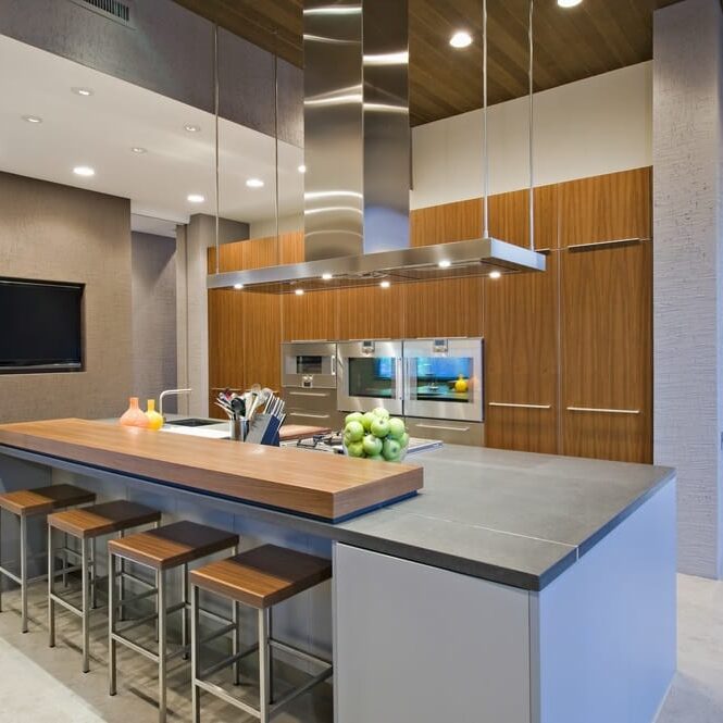 large wooden-topped island with stainless steel bar