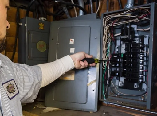 Professional Hot Shot Electric certified electrician upgrading breaker box – licensed Tulsa experts fix tripped breakers and install modern panels for safe home power.