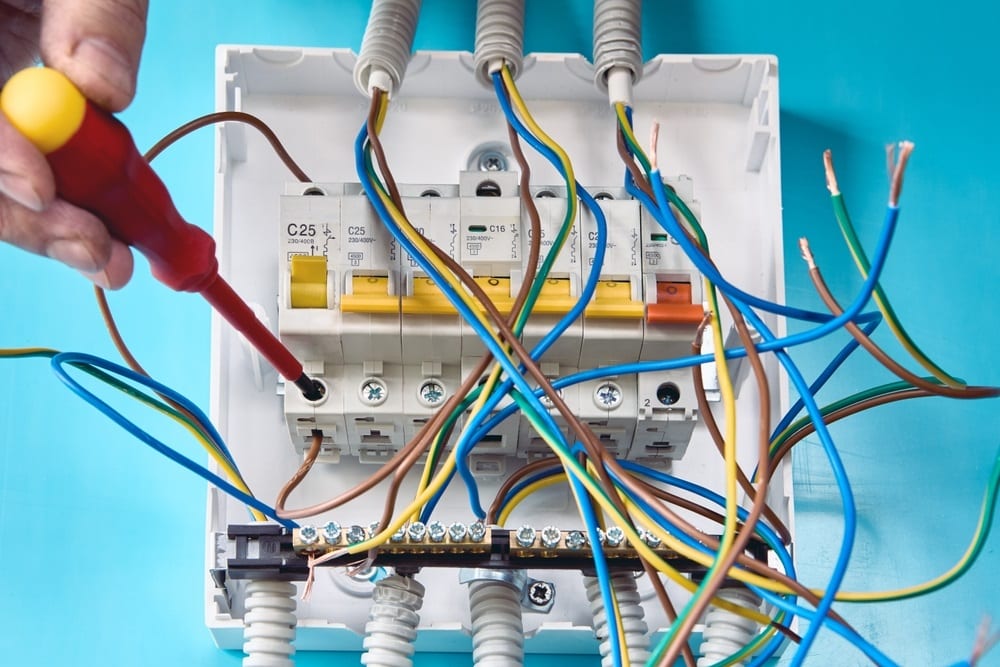 Professional Hot Shot Electric certified electrician upgrading breaker box – licensed Tulsa experts fix tripped breakers and install modern panels for safe home power.