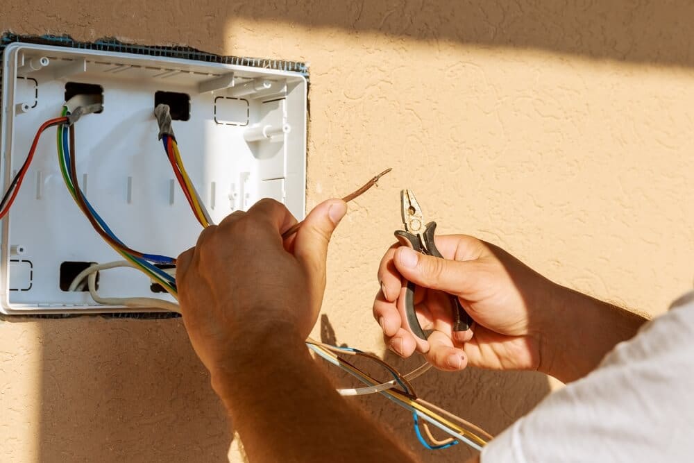 Professional Hot Shot Electric certified electrician upgrading breaker box – licensed Tulsa experts fix tripped breakers and install modern panels for safe home power.