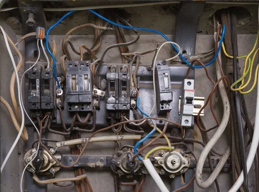 Damaged outdated breaker box with tripped breakers – professional Hot Shot Electric licensed experts diagnose and repair unsafe panels for home safety in Tulsa OK.